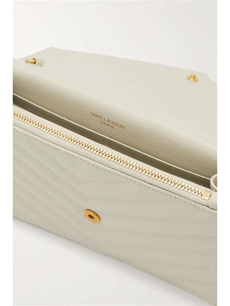 Cassandre matelassé envelope leather wallet on chain in white.